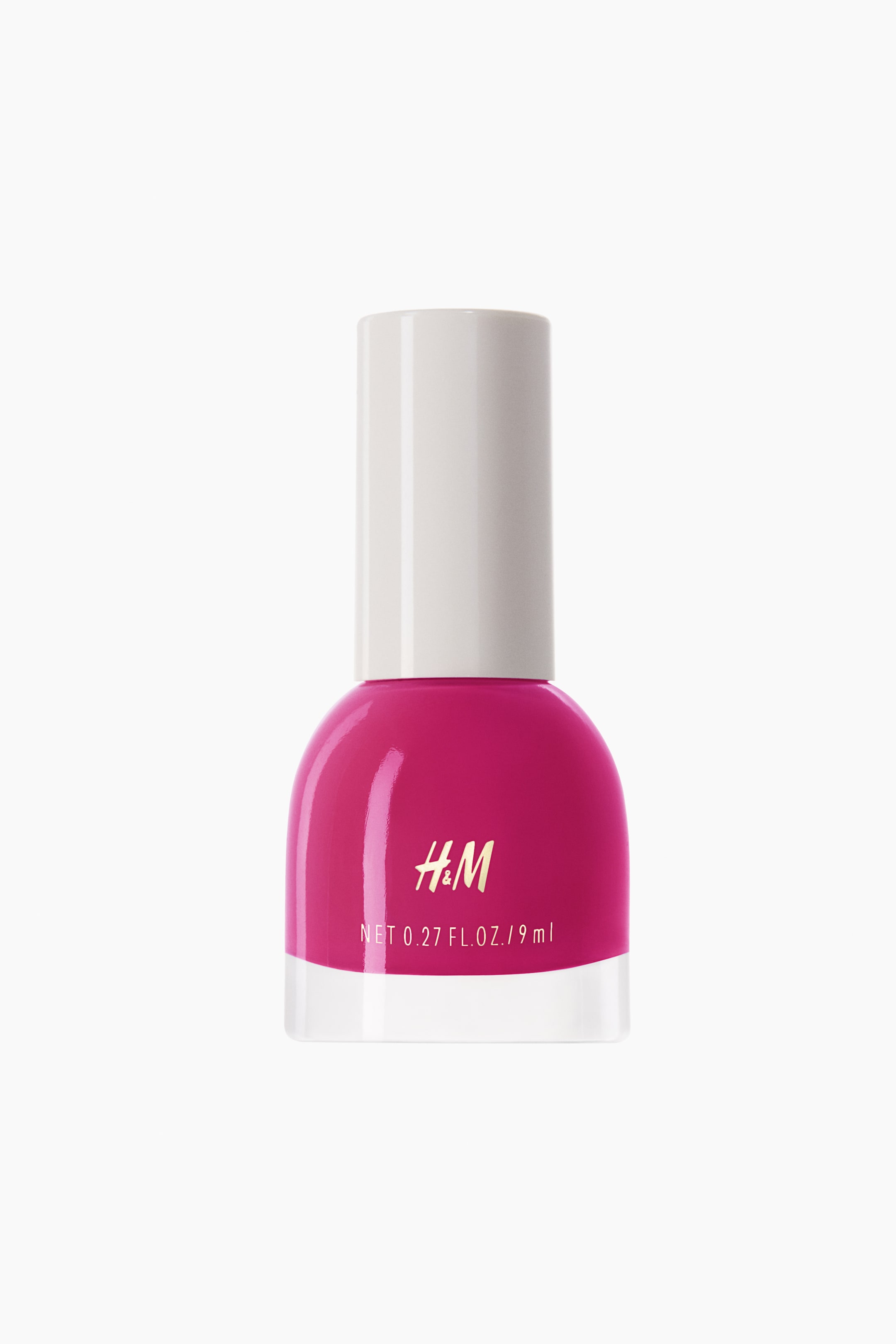 View larger image: The nail polish bottle showcases a vibrant fuchsia hue, with a rounded glass body, a transparent base, and a white cylindrical cap. The H&M logo along with "NET 0.27 FL. OZ. / 9 ml" is prominently displayed on the front of the bottle.