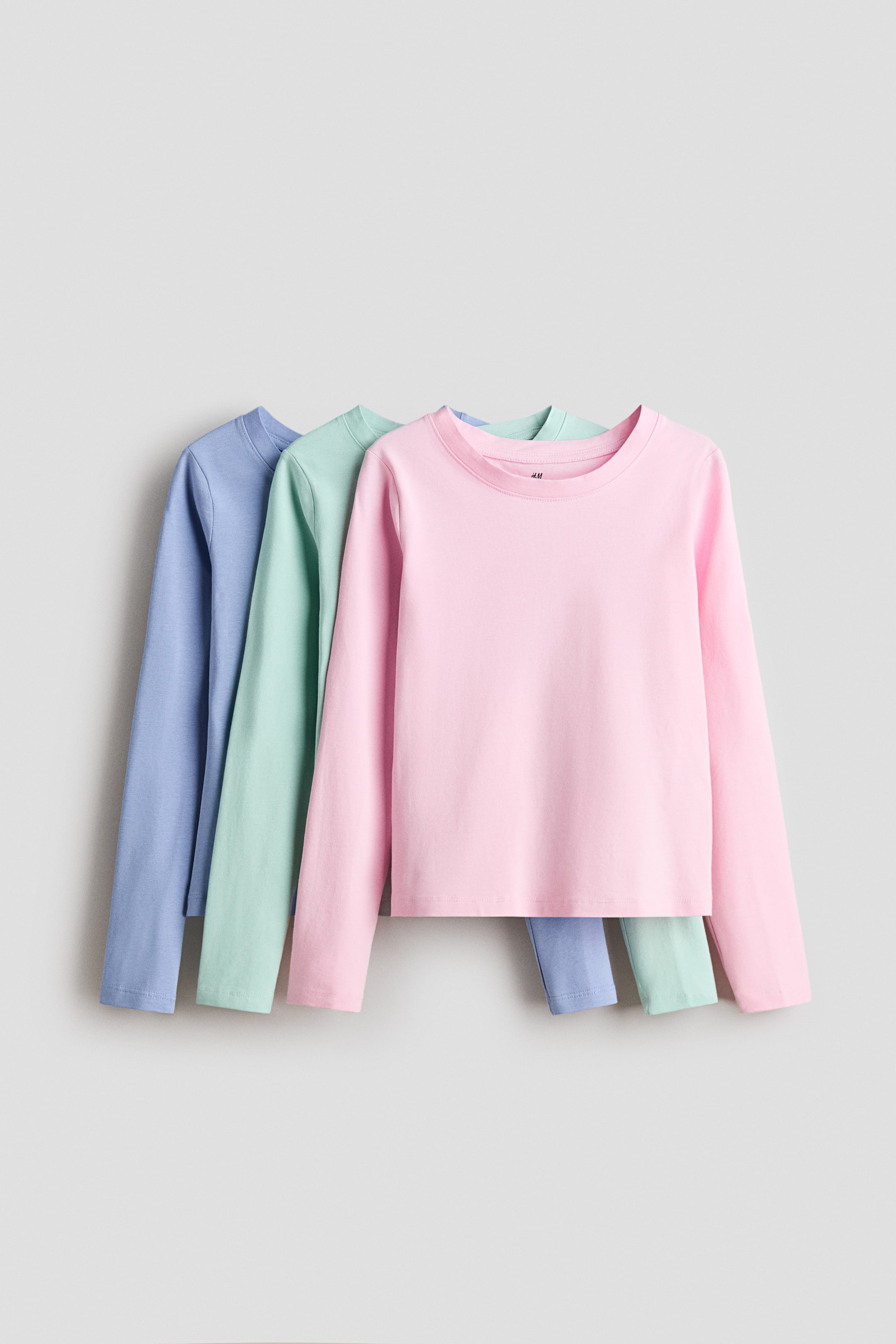 View larger image: Three long-sleeved tops in soft cotton jersey are featuring a round neckline. 