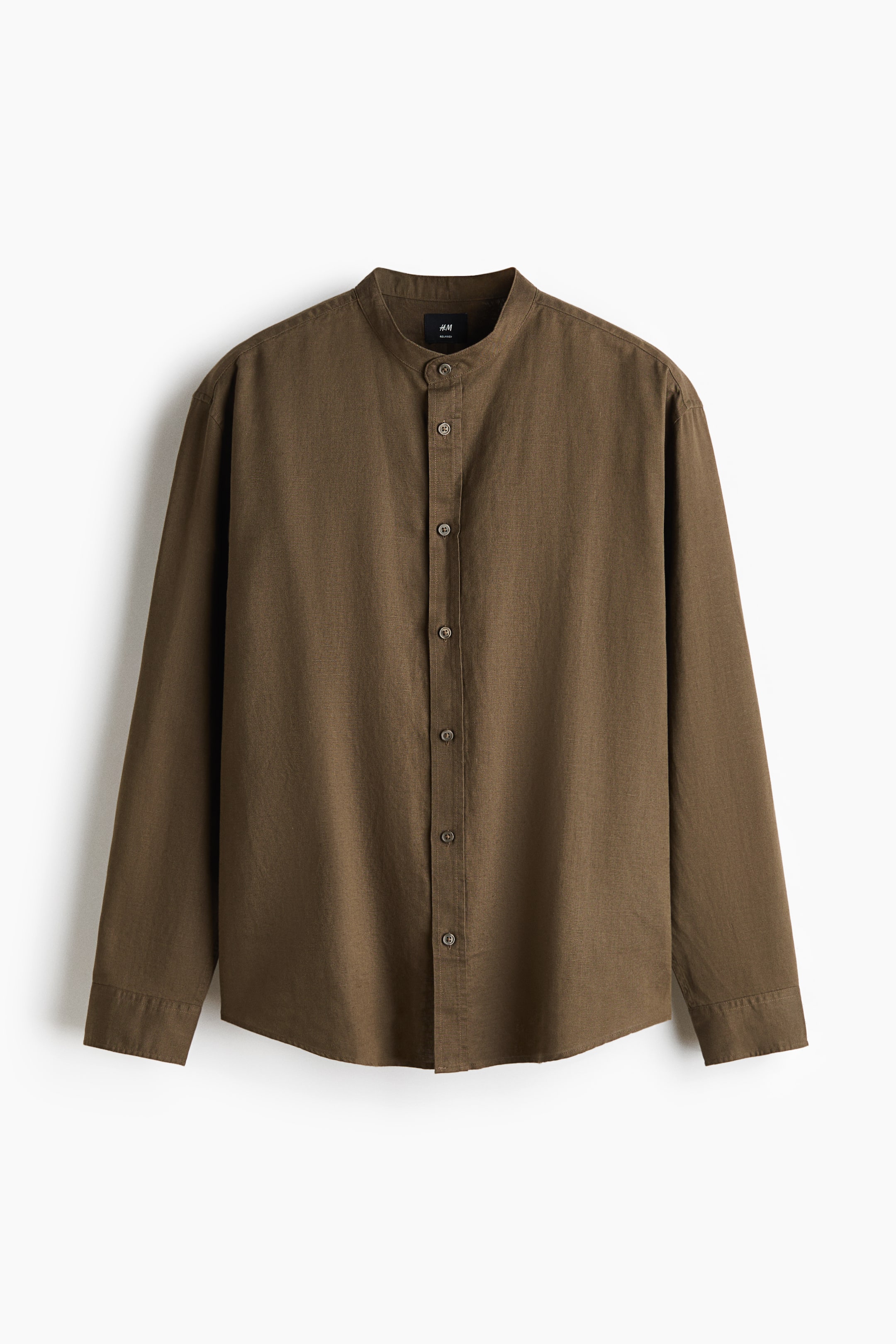 View larger image: A brown long-sleeved shirt is facing front, featuring a band collar and a central button-down placket. The shirt is displaying a textured fabric with buttoned cuffs and a subtly curved hem.