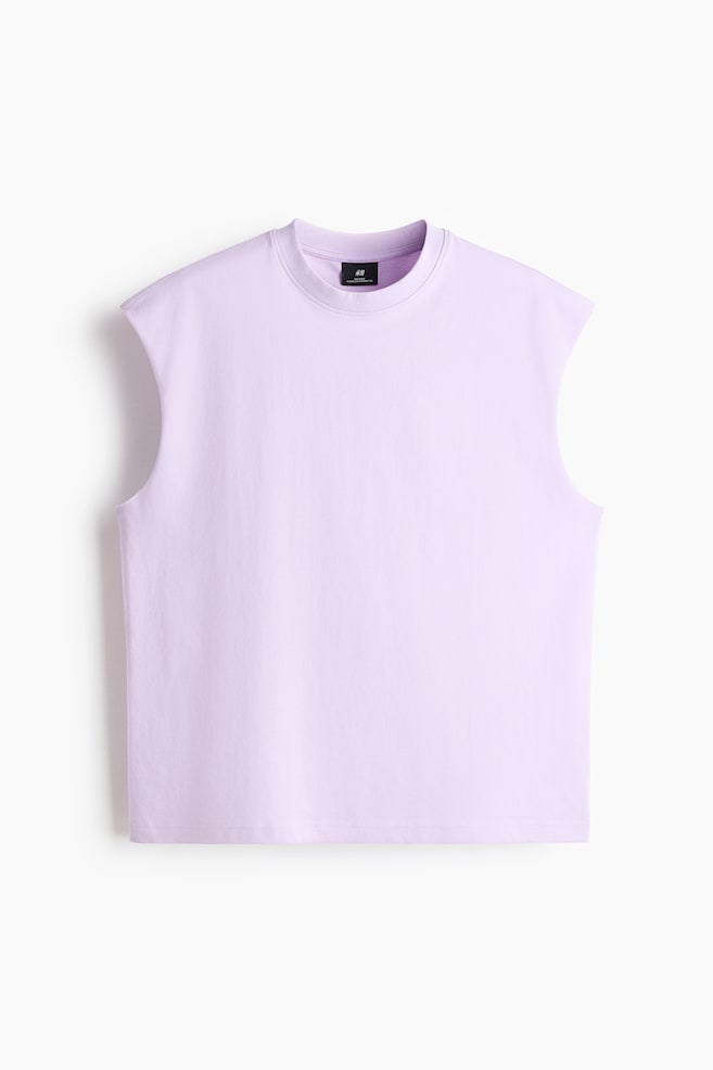A lavender sleeveless top is displayed front-facing, featuring a ribbed round neckline, wide armholes, and a straight hem. A black brand label appears inside the back of the neckline. - 1