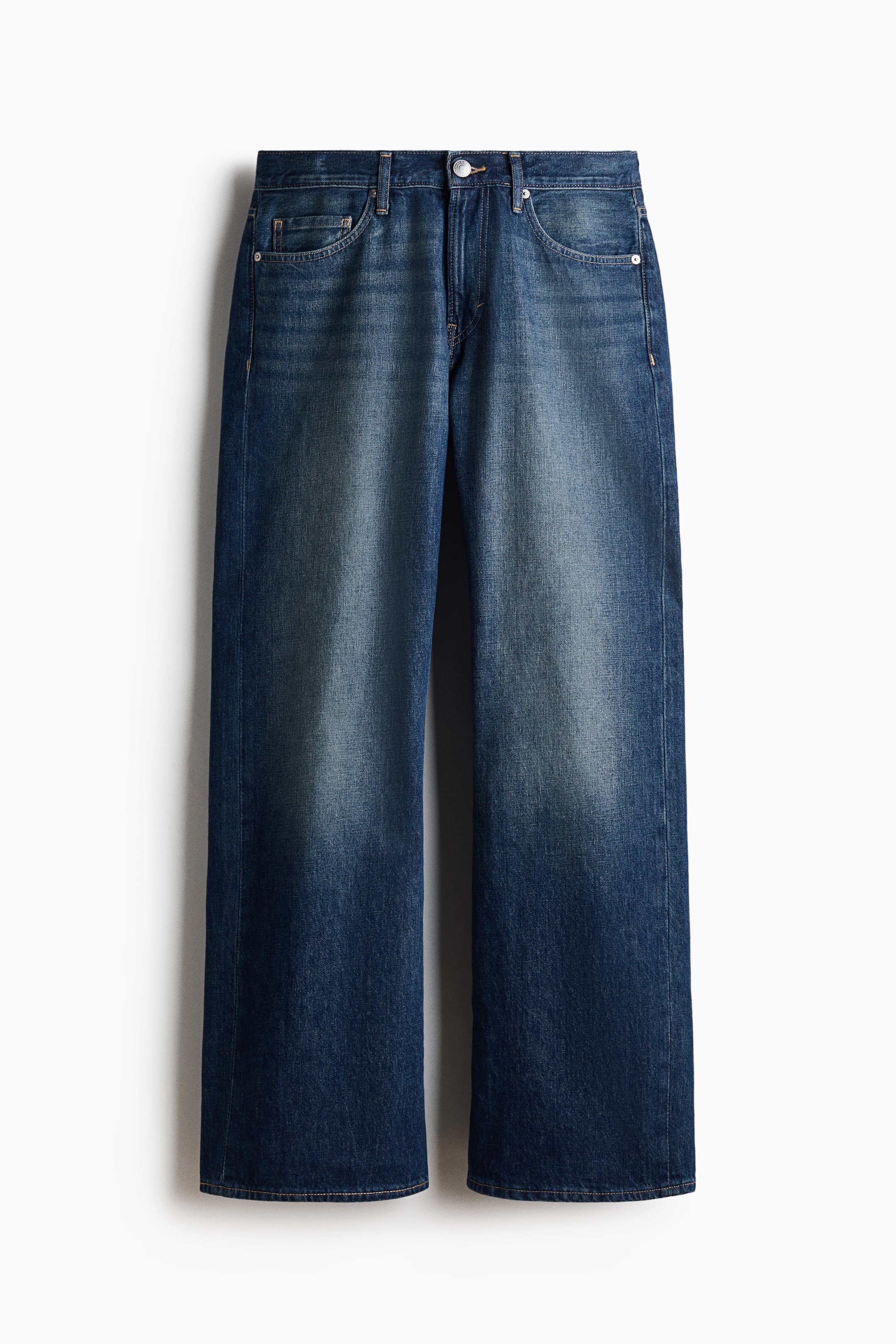 View larger image: A pair of dark blue denim jeans is shown from the front, featuring a relaxed fit with fading on the thighs, a button closure, zip fly, and front scoop pockets with small rivets.