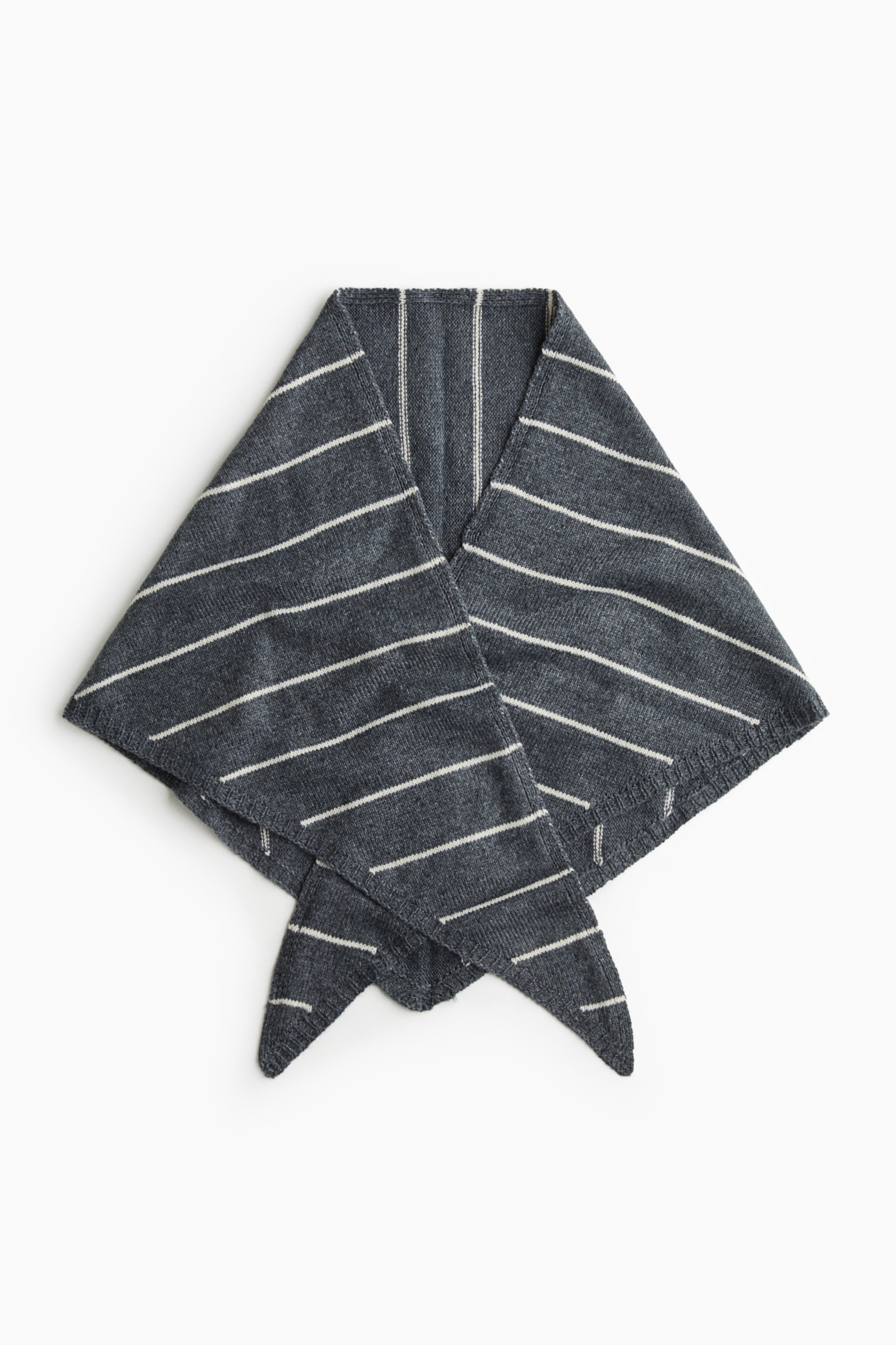 View larger image: A triangular scarf in a fine, dark grey knit is lying flat, displaying thin white horizontal stripes and ribbed borders. The scarf is folded in a front view with its pointed ends crossing over at the bottom.