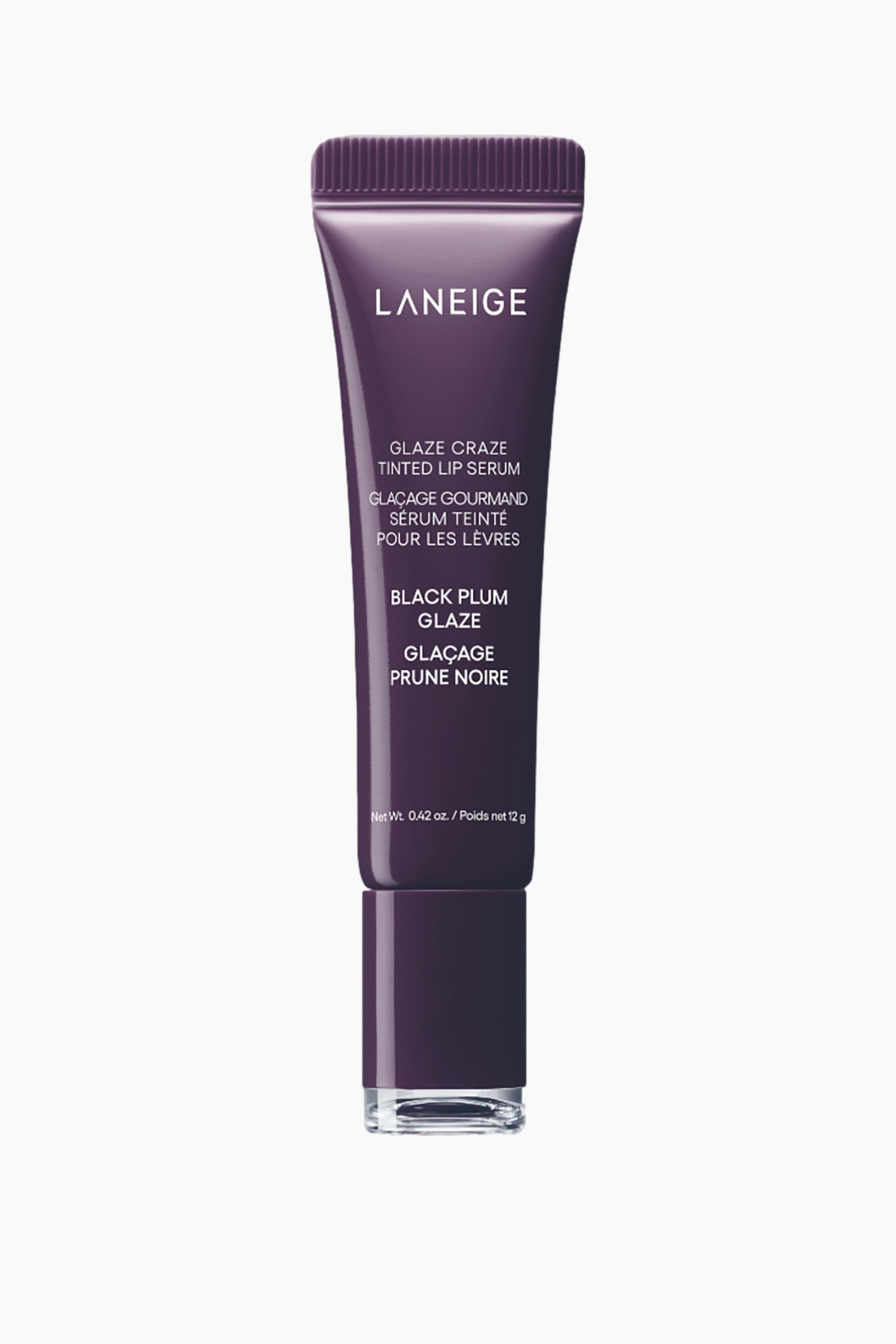 Näytä suurempi kuva: Tumma luumunvärinen Laneige Glaze Craze Tinted Lip Serum -putkilo seisoo pystyasennossa. Putkilo kapenee leveämmästä rungosta uurrettuun korkkiin, ja sen pinnalle on painettu valkoista tuotetietoa. Läpinäkyvä osa muodostaa sen kirkkaan pohjan.