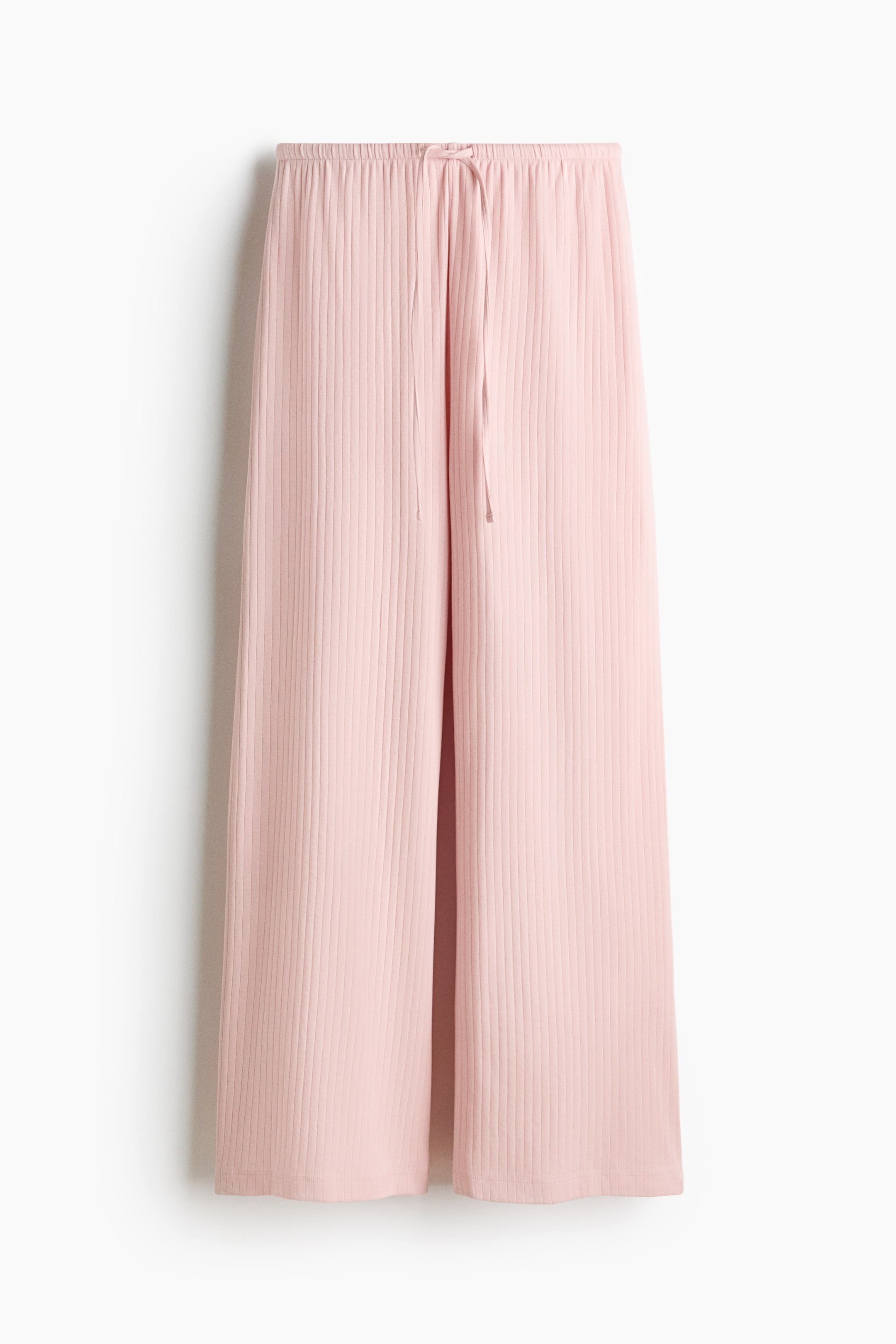 View larger image: The loose-fit pink trousers feature a ribbed cotton-jersey texture and an elasticated drawstring waist, visible at the FRONT.