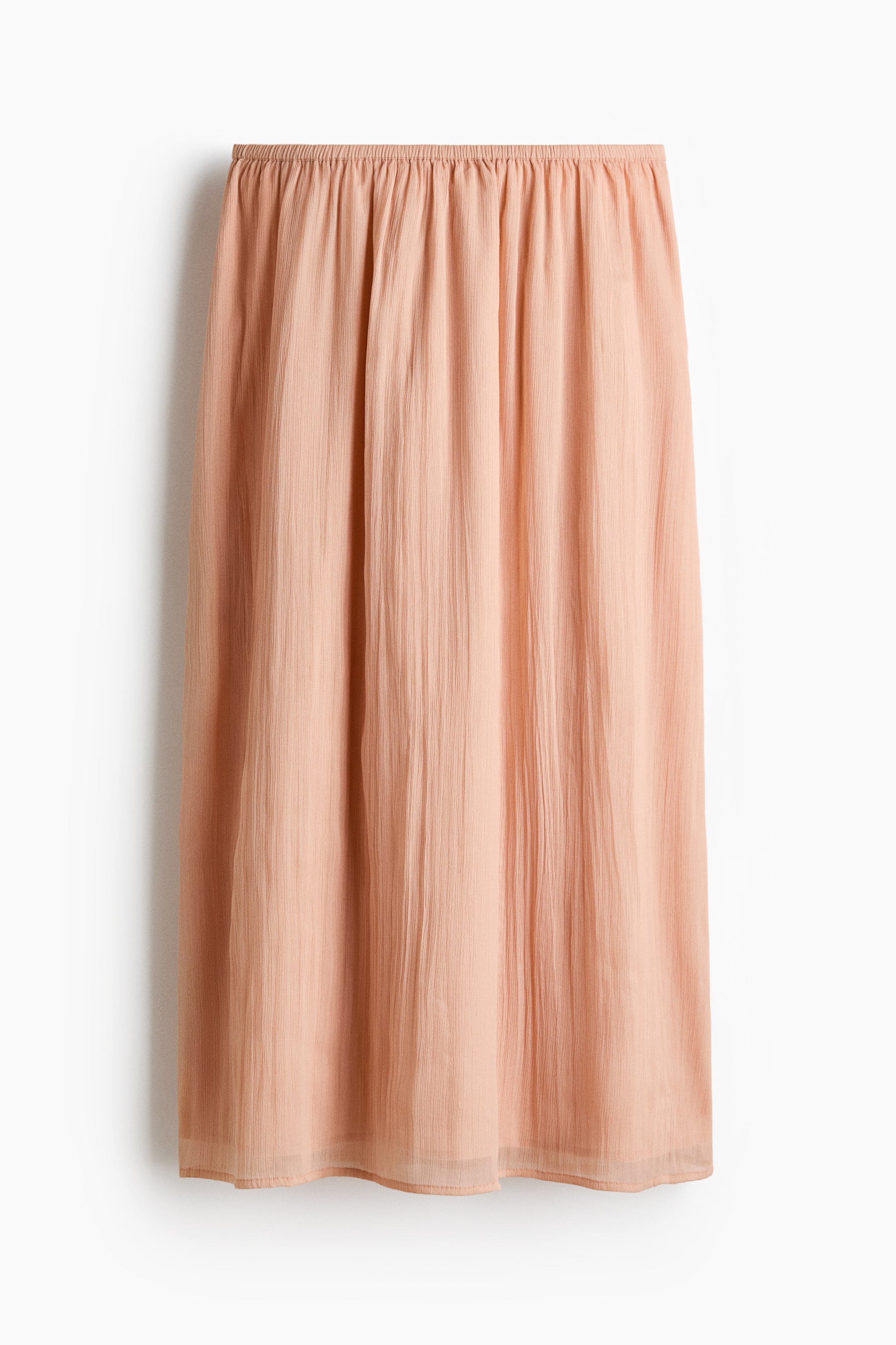 View larger image: The peach-hued skirt showcases its front with a crinkled texture all over. Designed with an elasticated, gathered waistband, it falls straight to a subtly sheer hem.