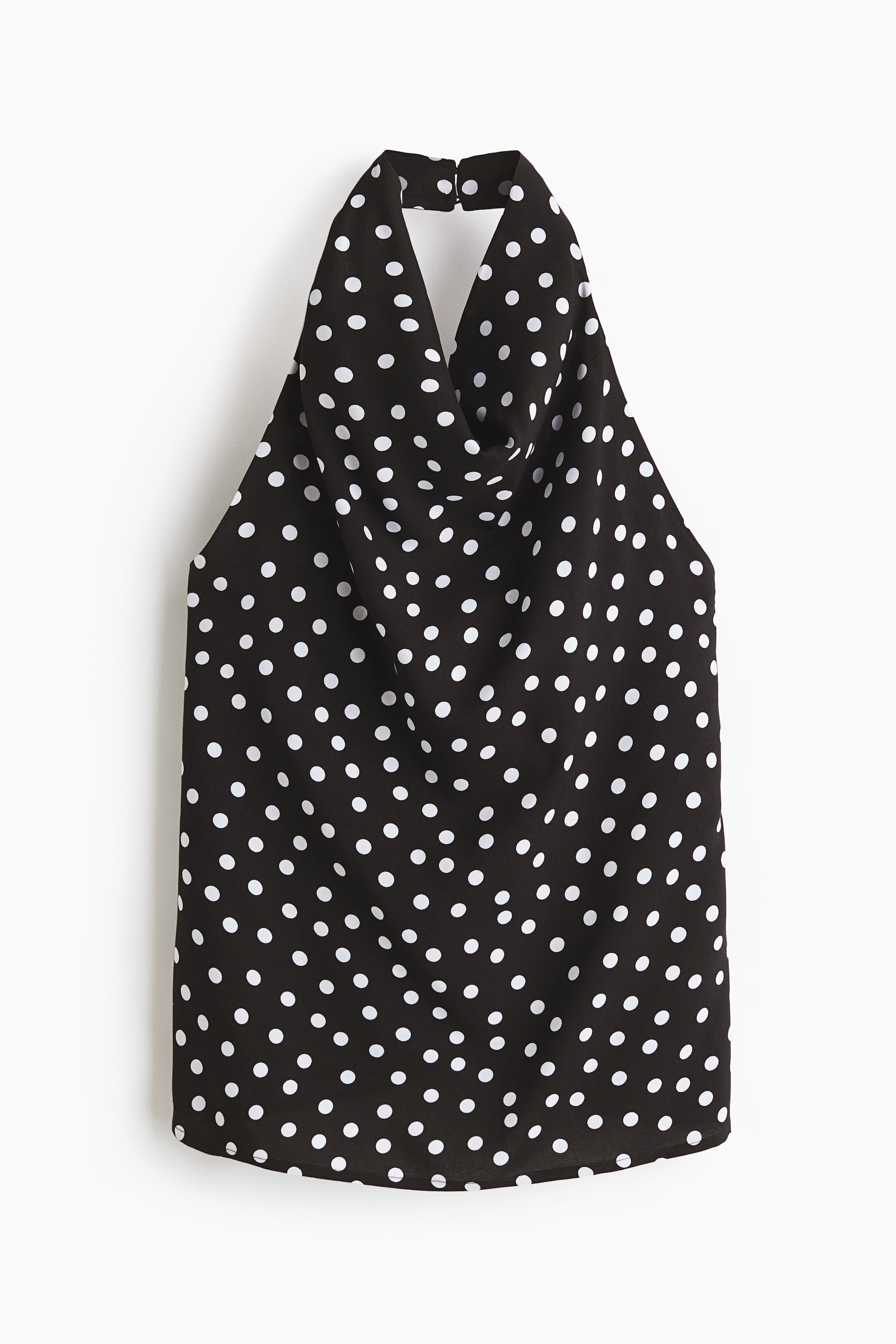 View larger image: Front view of a black halterneck top crafted in viscose weave, adorned with white polka dots throughout. It showcases a cowl neckline, a wide halterneck strap with a hook-and-eye closure at the back of the neck, and an open back design.