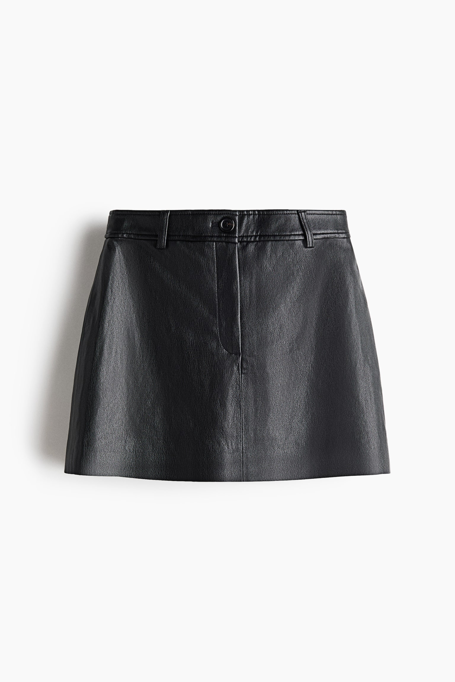A black leather mini skirt is facing the front, showcasing a structured A-line silhouette with a subtly textured finish. It features a fitted waistband with belt loops, a central button fastening, a concealed zip fly, and a vertical seam running down the centre.