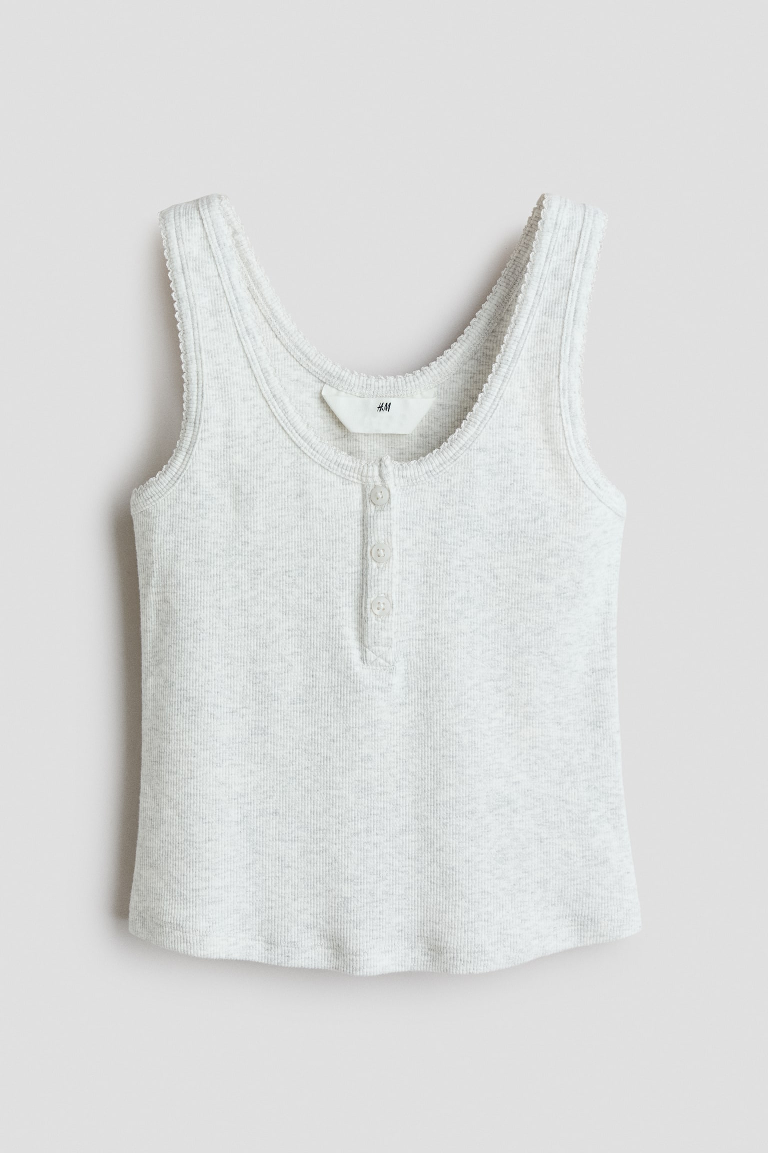 A light grey ribbed tank top is shown from the front, featuring a scoop neckline with delicate picot trim and a partial button placket with three buttons. The sleeveless top has a straight hemline and a soft, textured knit structure. - 1
