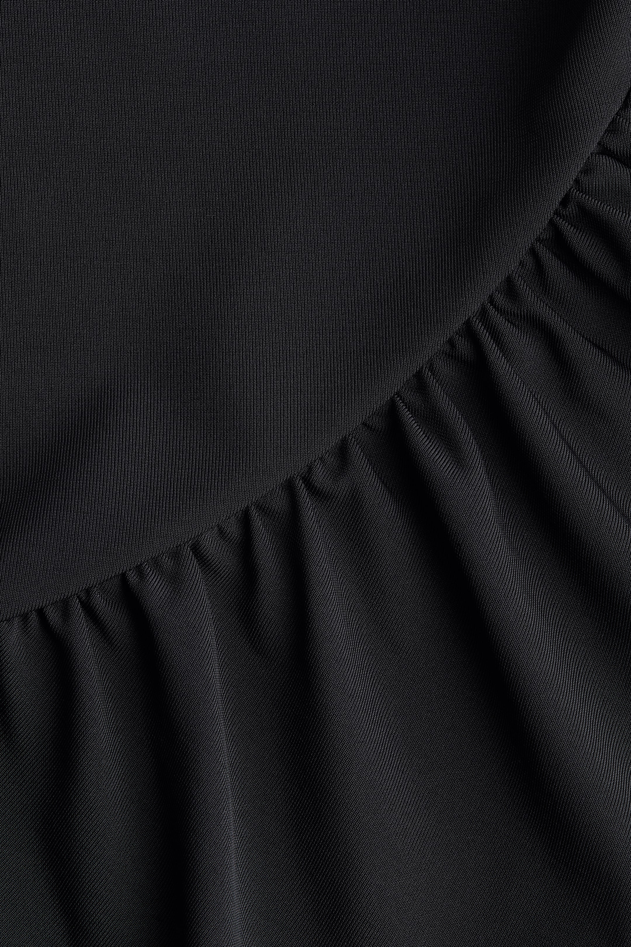 Maillot string à effet drapé