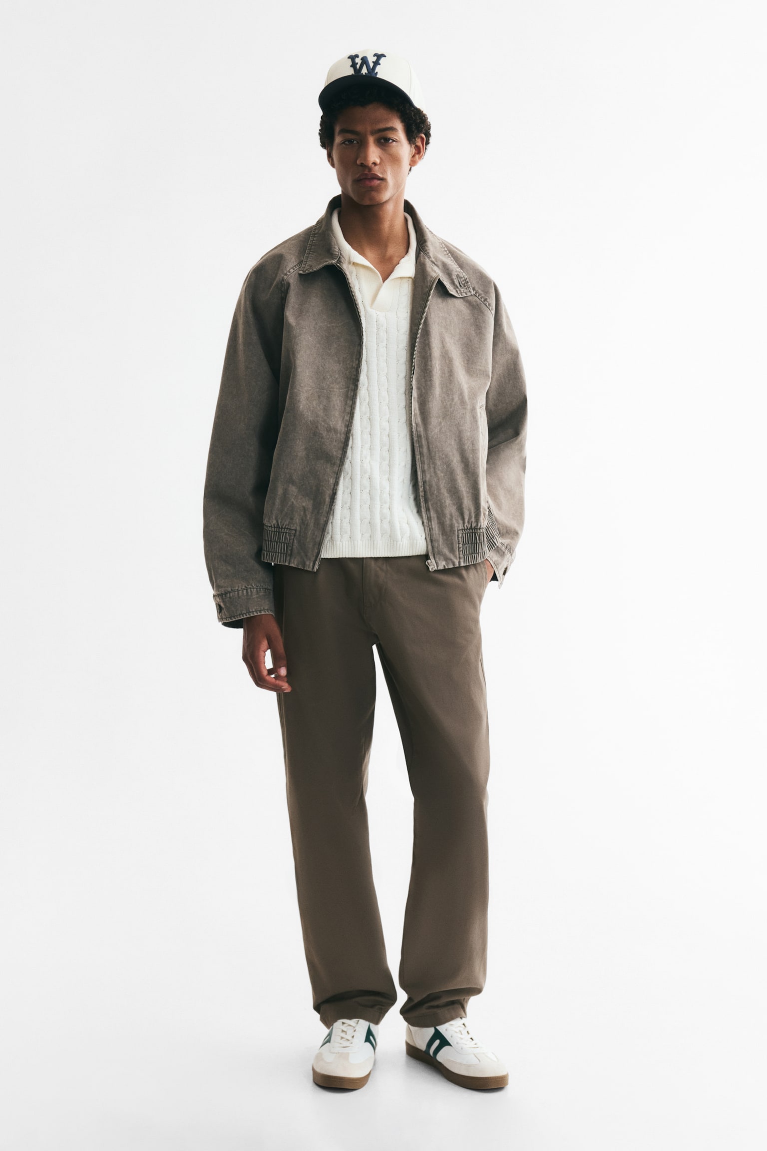 Brown trousers are presenting a front view, featuring a button and zip fastening, belt loops, and single front pleats. The trousers are displaying a straight-leg fit with a plain hem. - 1