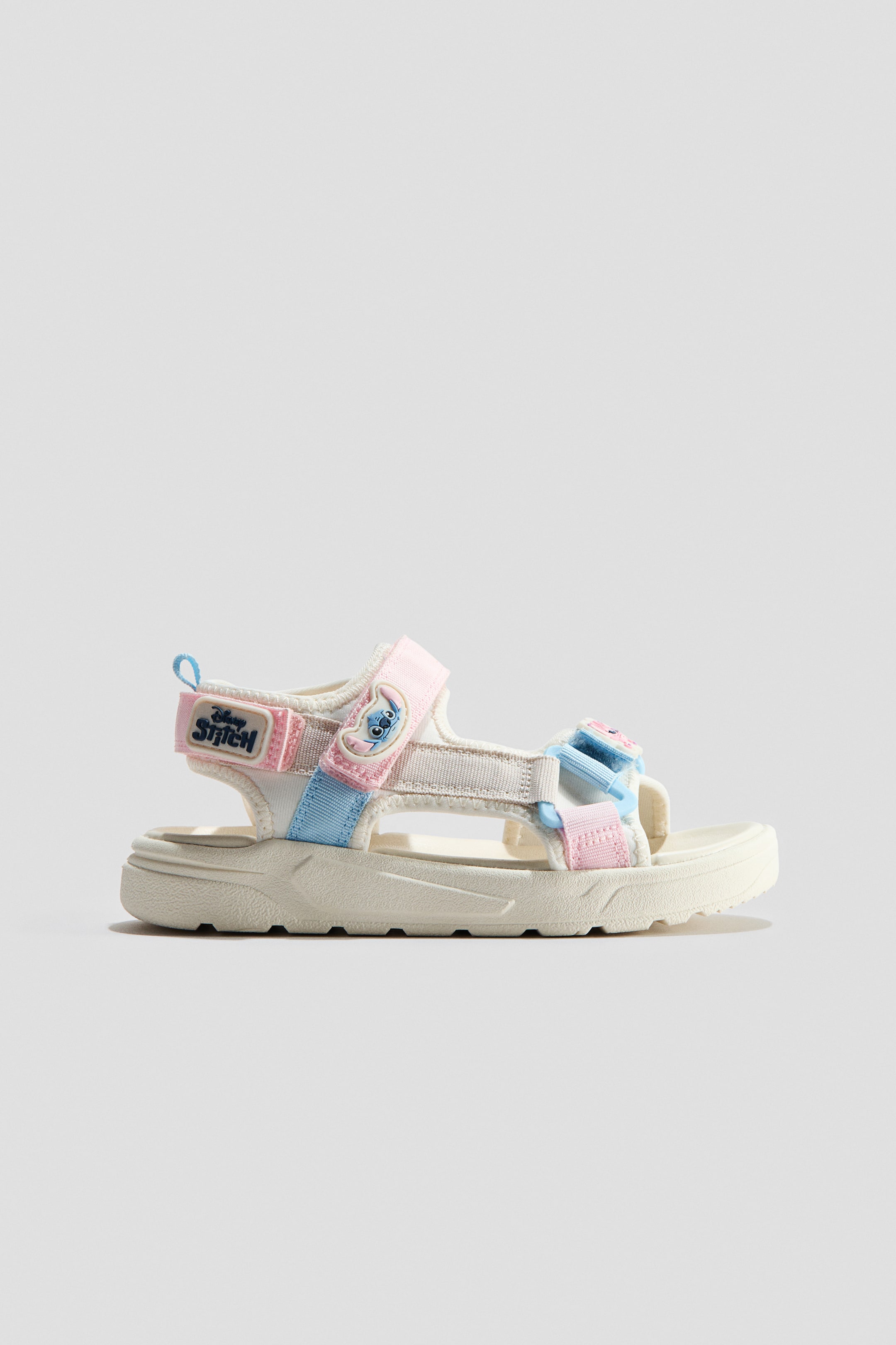 View larger image: The sandals showcase motif details, foot and ankle straps with a hook-and-loop closure, and a grosgrain loop at the back. They are crafted with molded insoles and fluted soles.