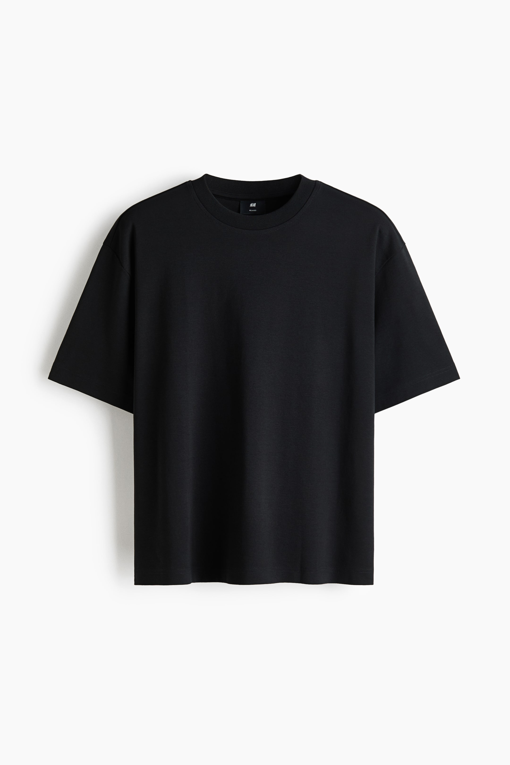 View larger image: A black t-shirt is facing front, featuring a ribbed crew neck and short sleeves with dropped shoulders. It is showcasing a relaxed, oversized fit, and a small black H&M size tag is visible on the inner back collar.