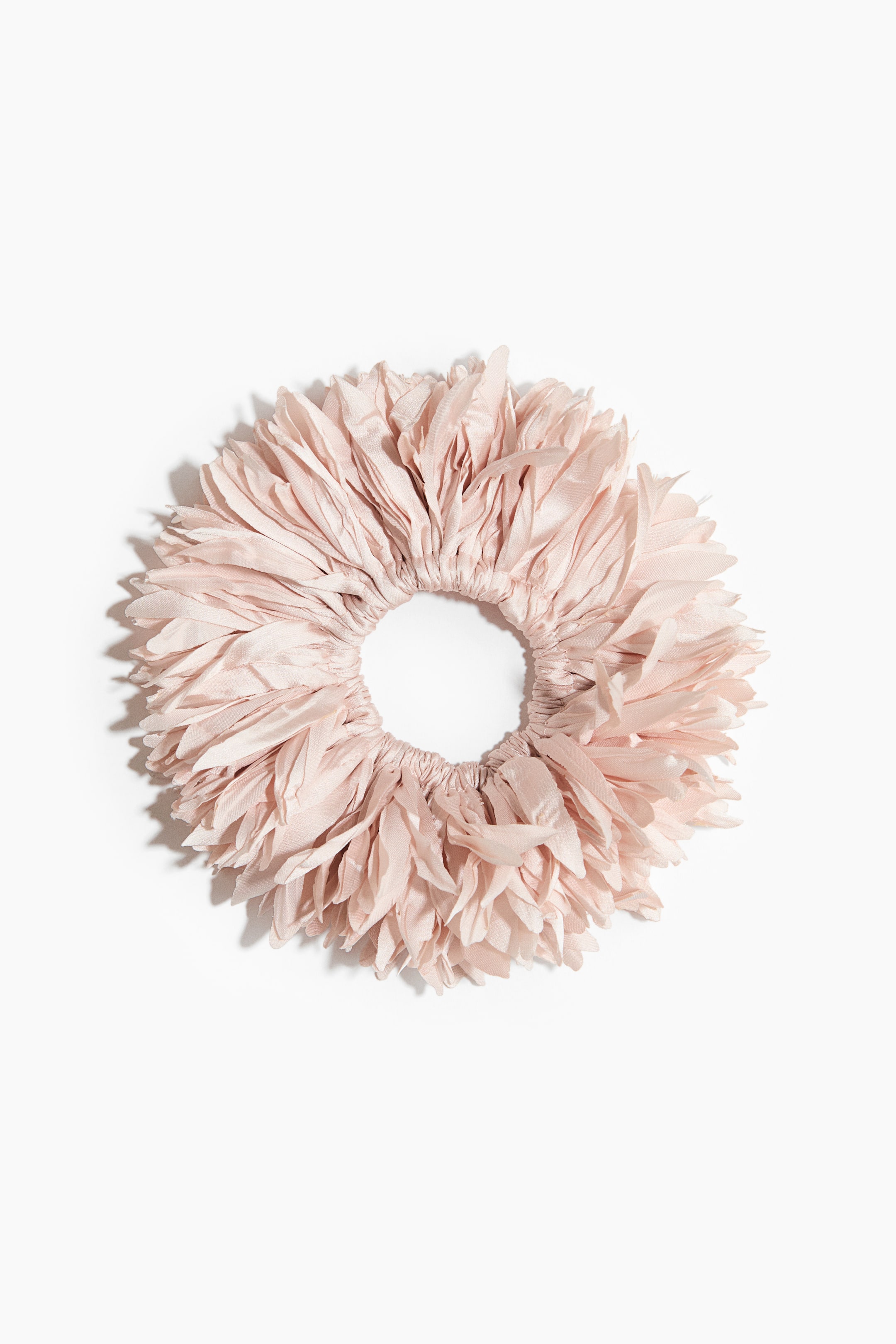 View larger image: A blush pink fabric scrunchie showcases multiple layered petal-like elements, offering a voluminous and textured look around its central elastic opening.