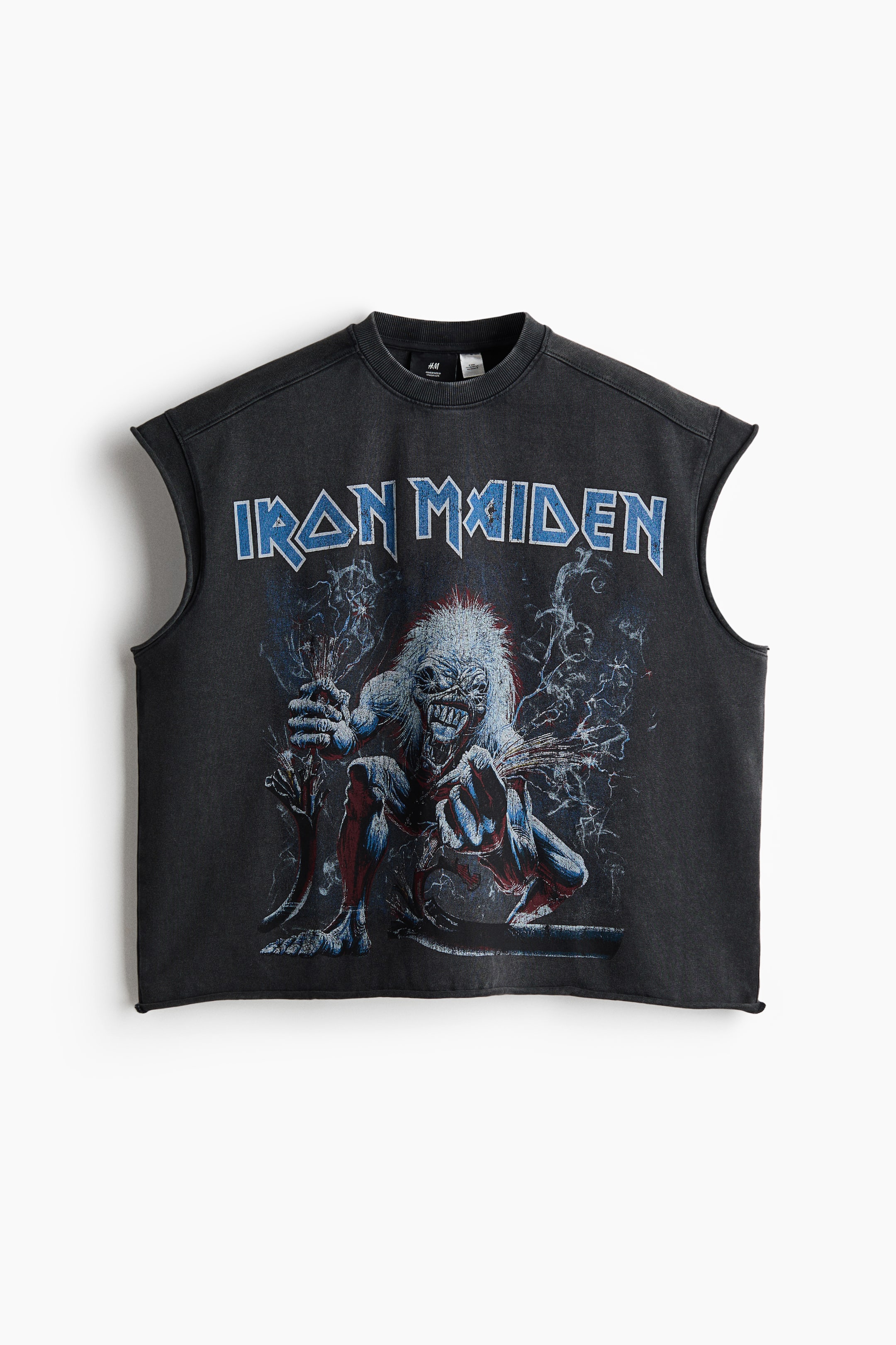 View larger image: A washed black sleeveless t-shirt showcases its front, featuring a crew neck and raw-cut armholes. The front displays a blue "Iron Maiden" text above a detailed graphic print of a monster with white hair and clawed hands, set amidst blue and white smoky elements.