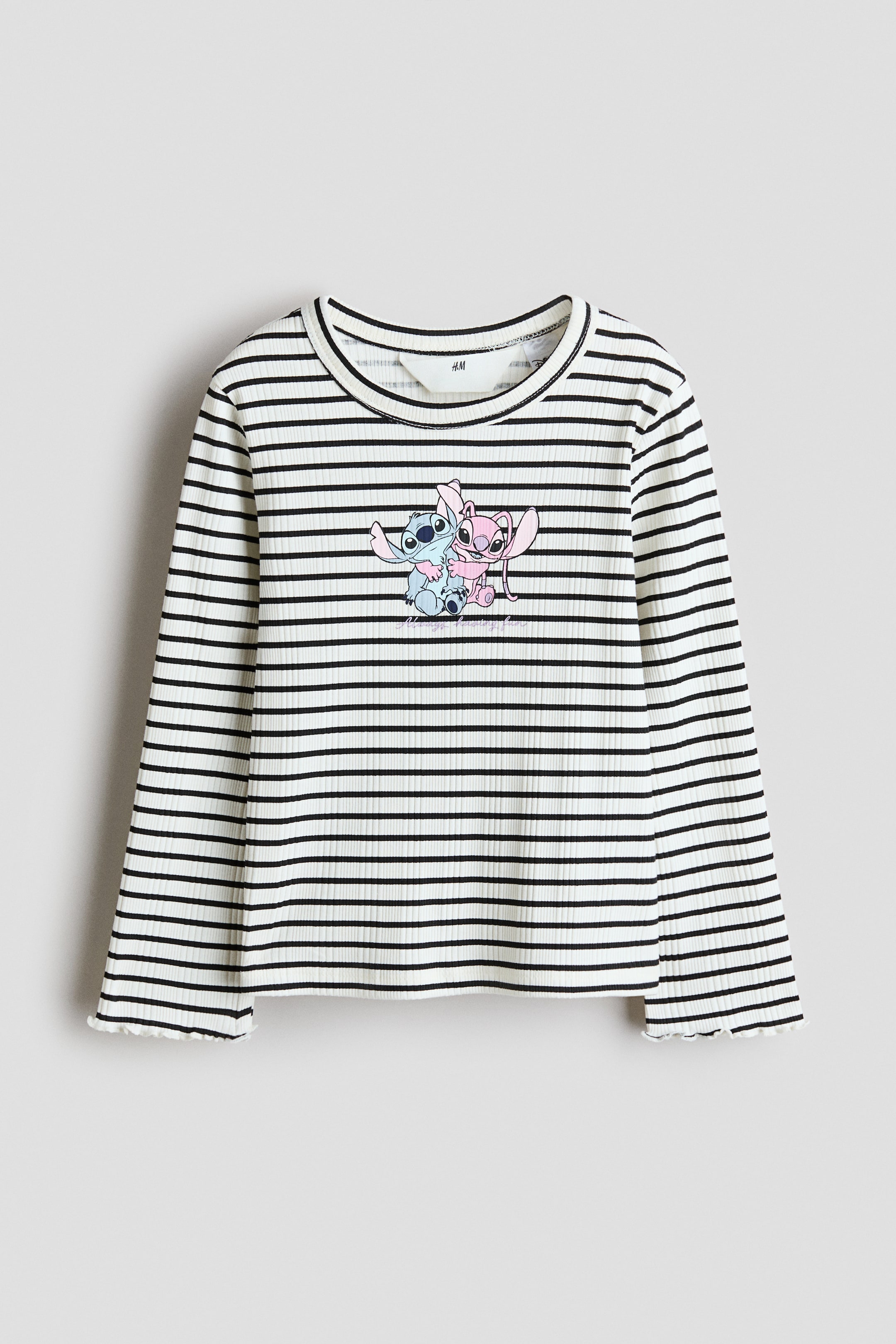 View larger image: This front-facing ribbed cotton-jersey top features horizontal black and off-white stripes, a round neckline and long sleeves. It displays a graphic print of two stylized cartoon characters and text on the chest, with overlocked edges finishing the cuffs.