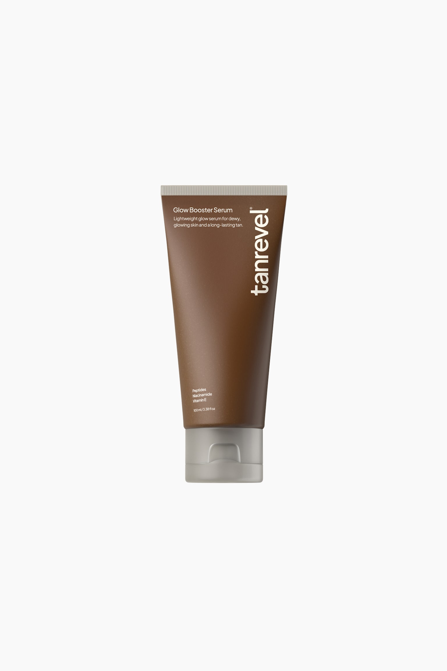 Glow Booster Serum seisoo pystyasennossa mattapintaisessa ruskeassa puristeliputkessa, jonka alaosassa on kontrastina harmaa läppäkorkki. Etupuolelle suunnattu tuubi näyttää valkoista tekstiä, jossa kerrotaan tuotteen nimi, keskeiset ainesosat sekä oikeaa reunaa pitkin kulkeva pystysuuntainen "tanrevel"-brändäys.