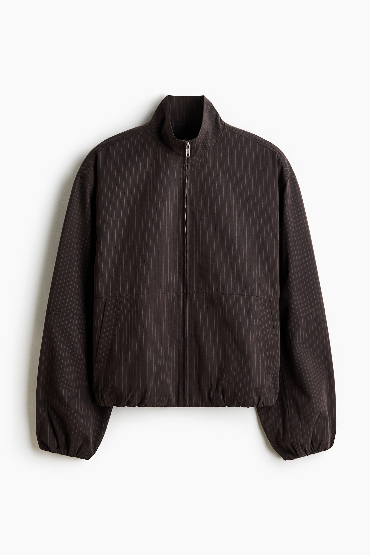 A dark brown jacket with thin vertical pinstripes showcases its front, featuring a stand-up collar, a full-length silver front zip, and elasticated cuffs and hem, with two discreet side pockets.