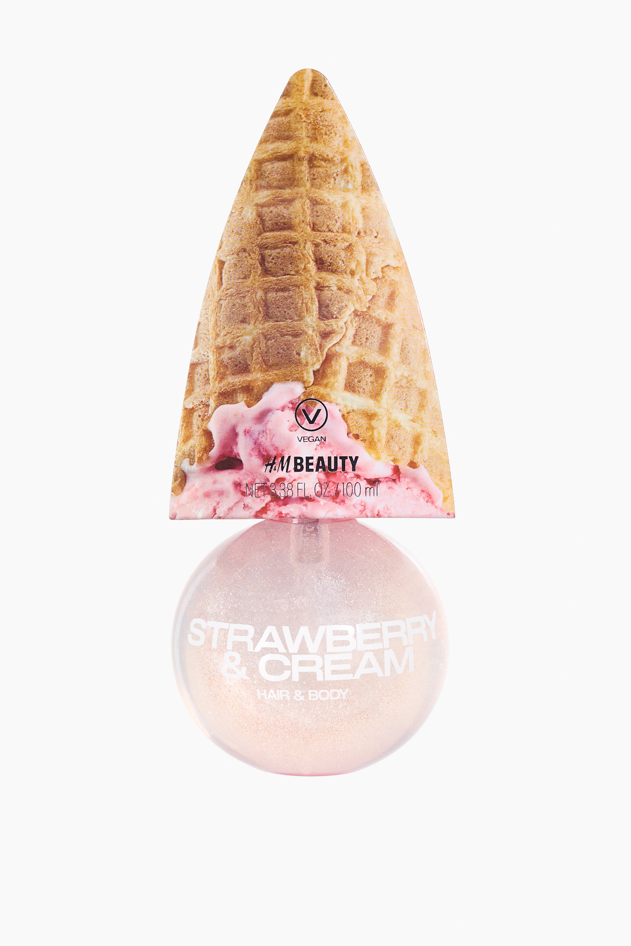 View larger image: An H&M Beauty Strawberry & Cream Hair & Body Shimmer Spray bottle is standing upright, facing forward. The spherical, translucent bottle contains a light pink, shimmery liquid, with a cone-shaped cardboard top depicting a waffle ice cream cone and melting pink ice cream resting on its pump.