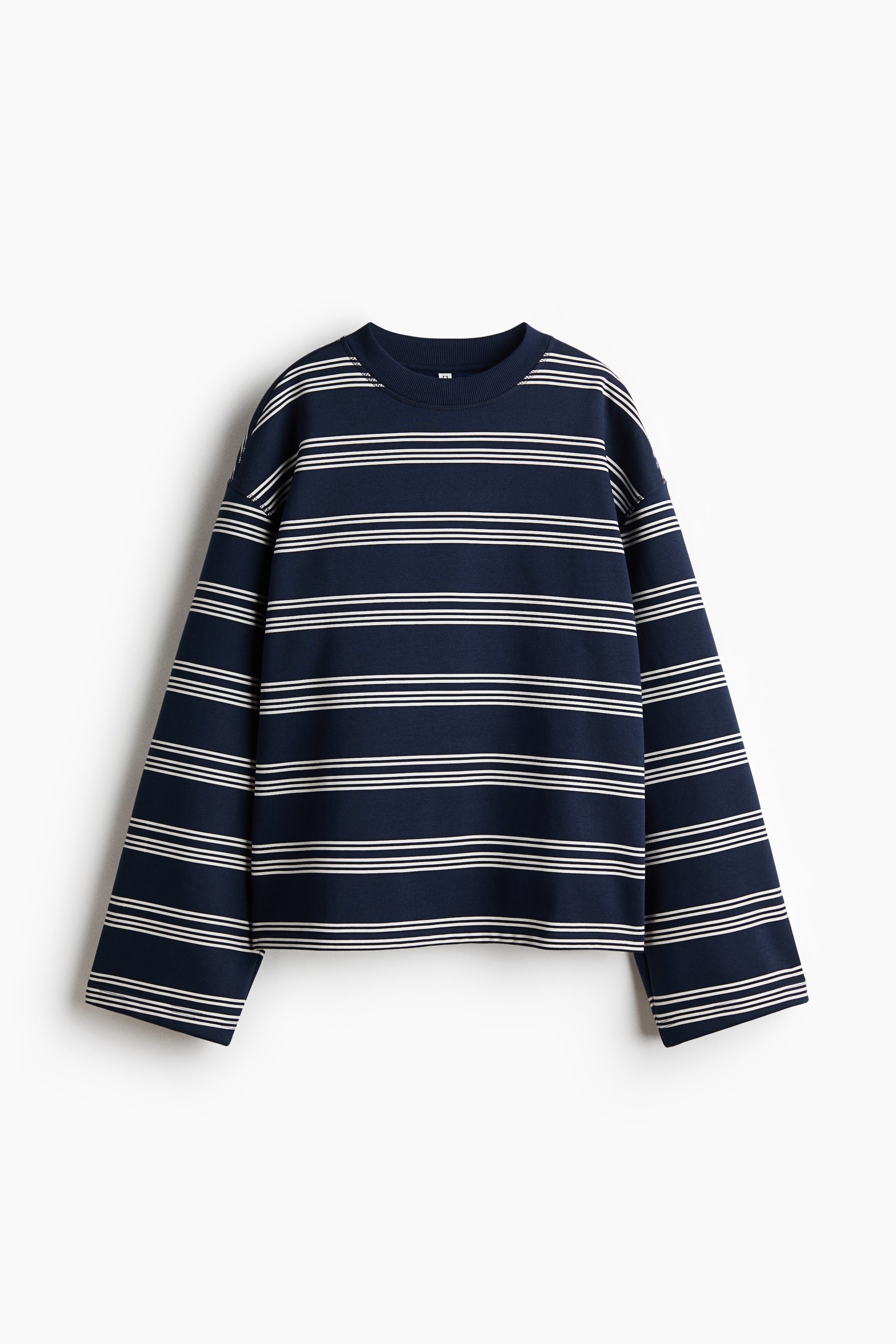 View larger image: An oversized, long-sleeved top is shown from the front, made from navy blue sweatshirt fabric and featuring white horizontal stripes. It is designed with a round, rib-trimmed neckline and dropped shoulders.