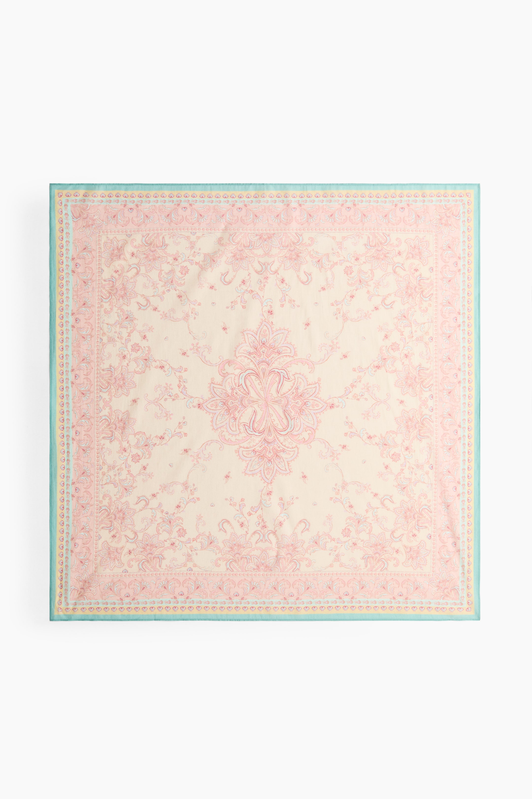 View larger image: A square scarf is laid flat, viewed from the front, showcasing a soft weave. It boasts an intricate printed pattern with pink and light blue floral and paisley motifs on a light cream background, framed by a light blue border at its edges.
