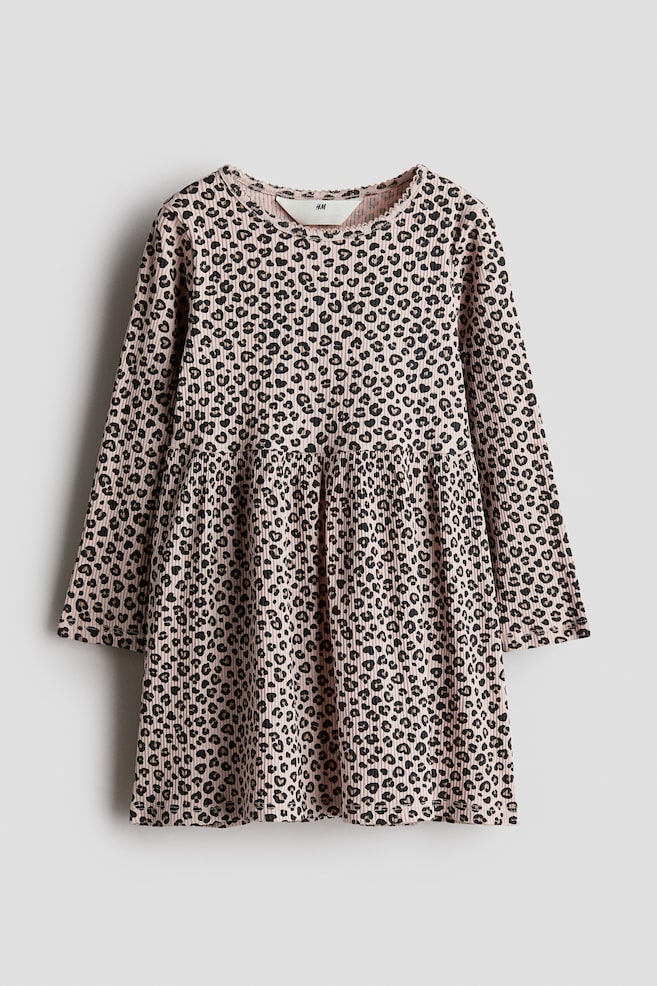 A long-sleeve dress in pink ribbed cotton jersey with an all-over leopard print is shown facing front, featuring a round neckline with picot trim, a gathered seam at the waist, and a flared skirt. - 1