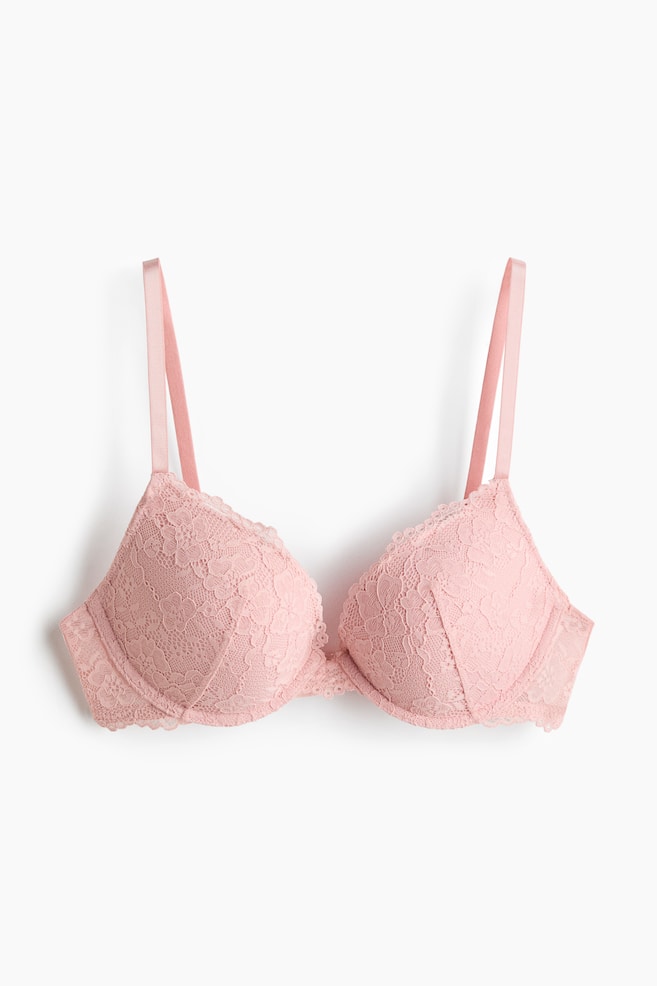 A pink lace push-up bra is displayed from the front, featuring adjustable shoulder straps and underwired, padded cups with a floral lace overlay. - 1