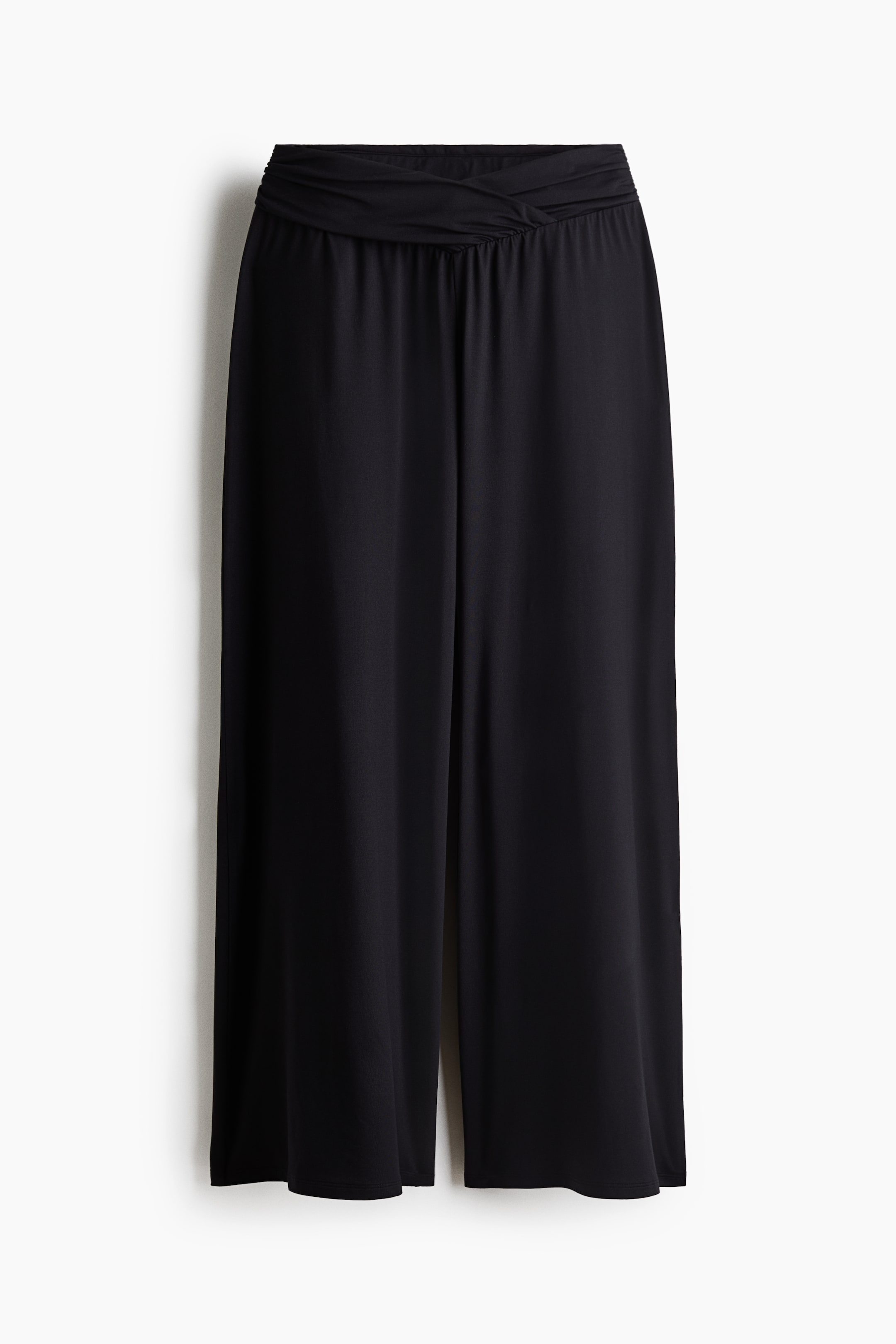View larger image: Black wide-leg pants are facing forward, showcasing a ruched waistband with a twisted detail at the center. The fabric drapes smoothly down the legs.