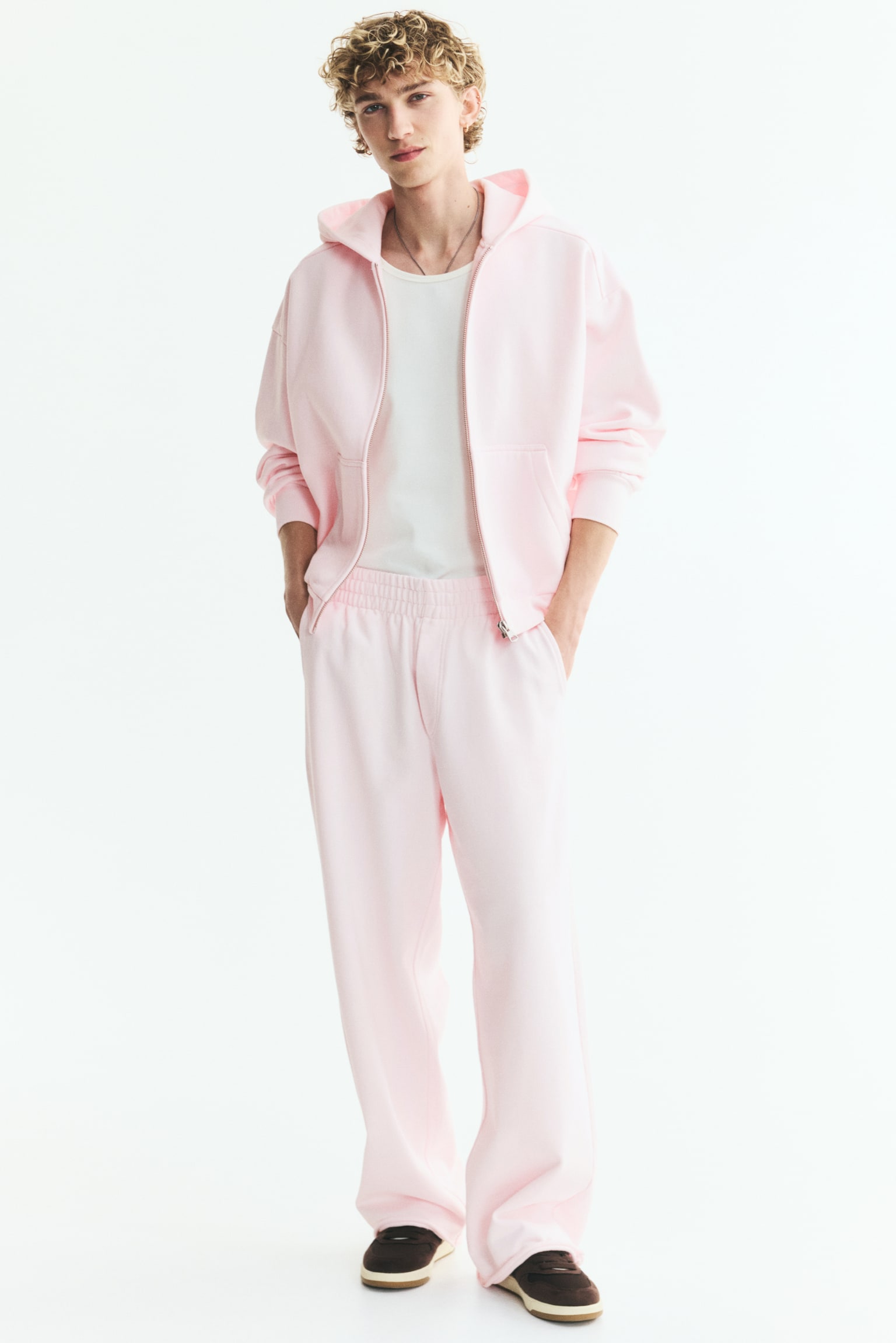Pink wide-leg cropped pants are lying flat, front-facing. They are featuring an elasticated waistband, slanted side pockets, and raw-edge hems. - 1