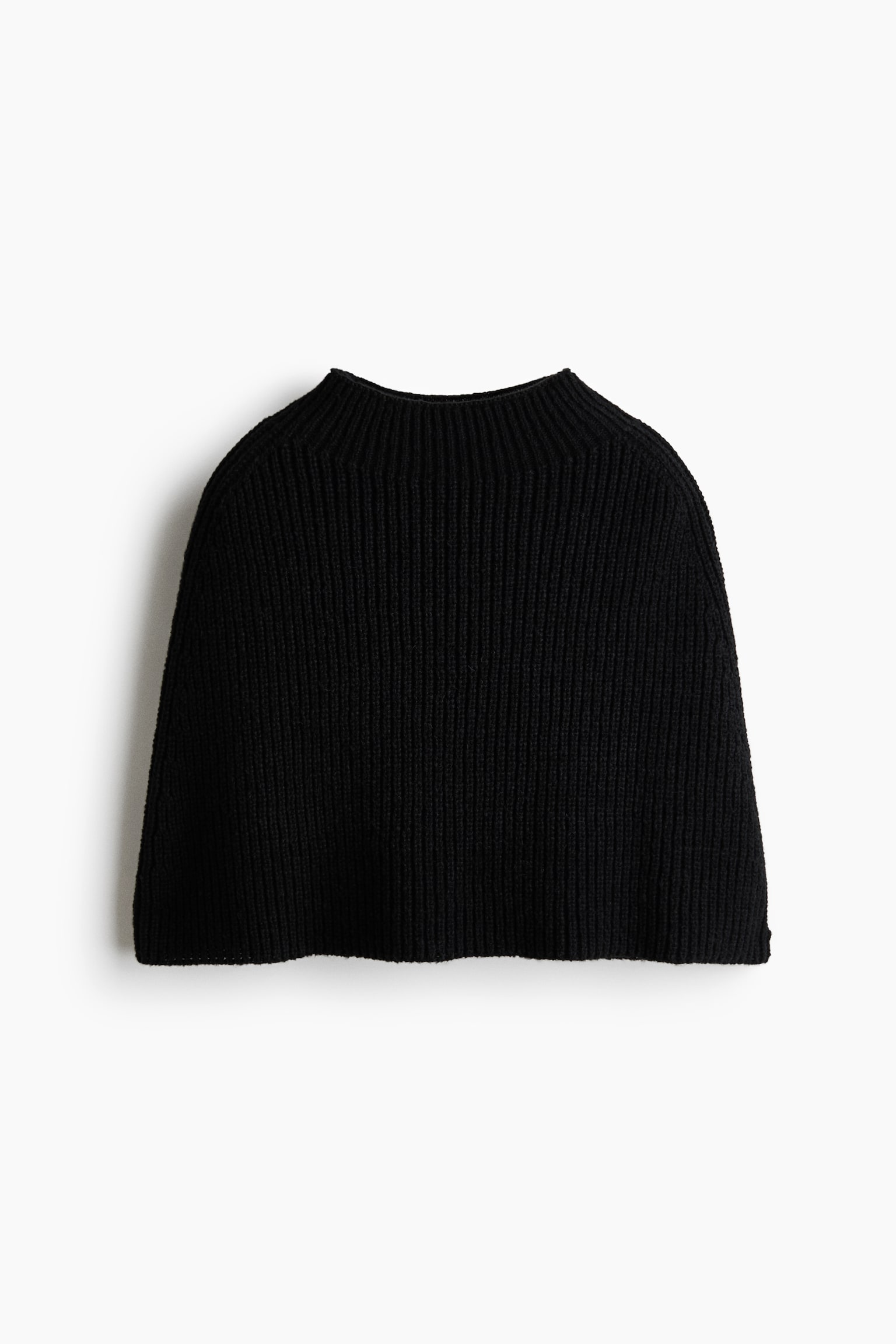 A black ribbed knit capelet is shown from the front, featuring a high mock neck and a flared drape that covers the shoulders. The garment displays a consistent vertical ribbed texture throughout.