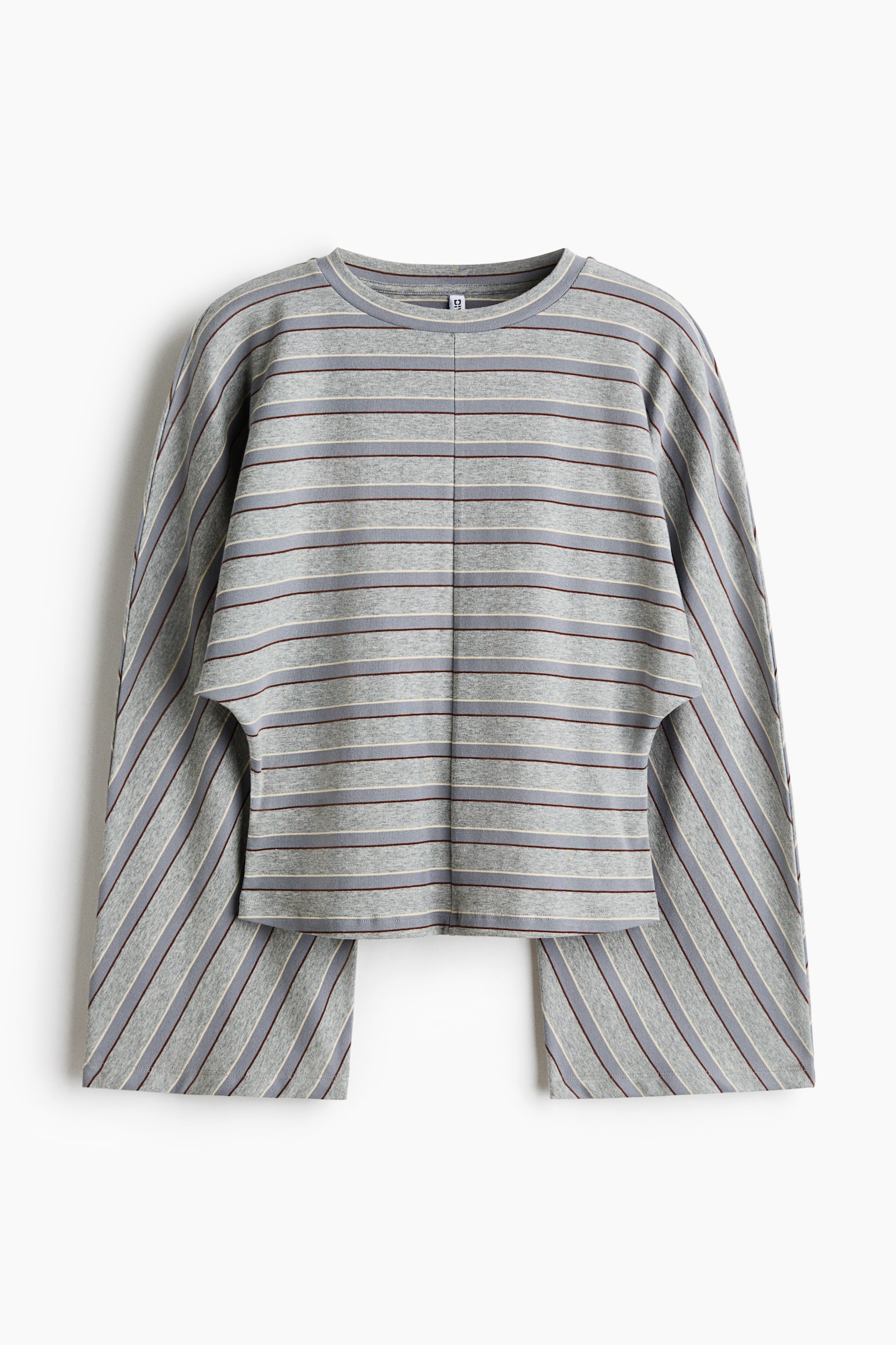 A grey long-sleeved top is shown from the front, featuring a crew neck, a vertical centre seam, and horizontal stripes in burgundy and cream. The garment features wide, open-sided cape sleeves with diagonally aligned stripes that drape past the cropped hem of the body.