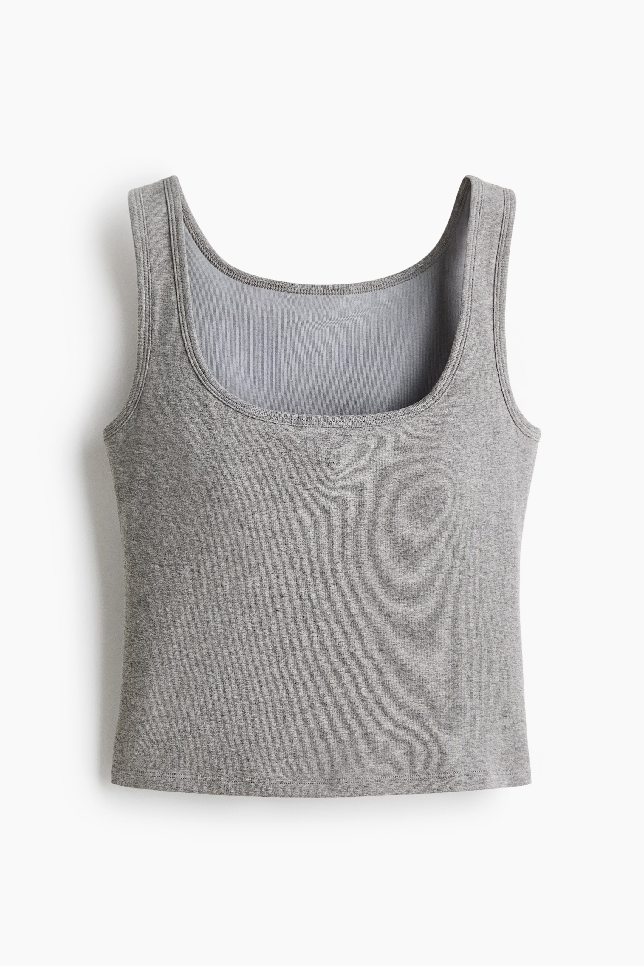 Xem ảnh lớn hơn: Chiếc áo thun ôm vừa màu xám được trình bày ở mặt trước, có dây vai rộng, cổ tròn và gấu cắt thẳng. Chất liệu cotton jersey mềm mại.