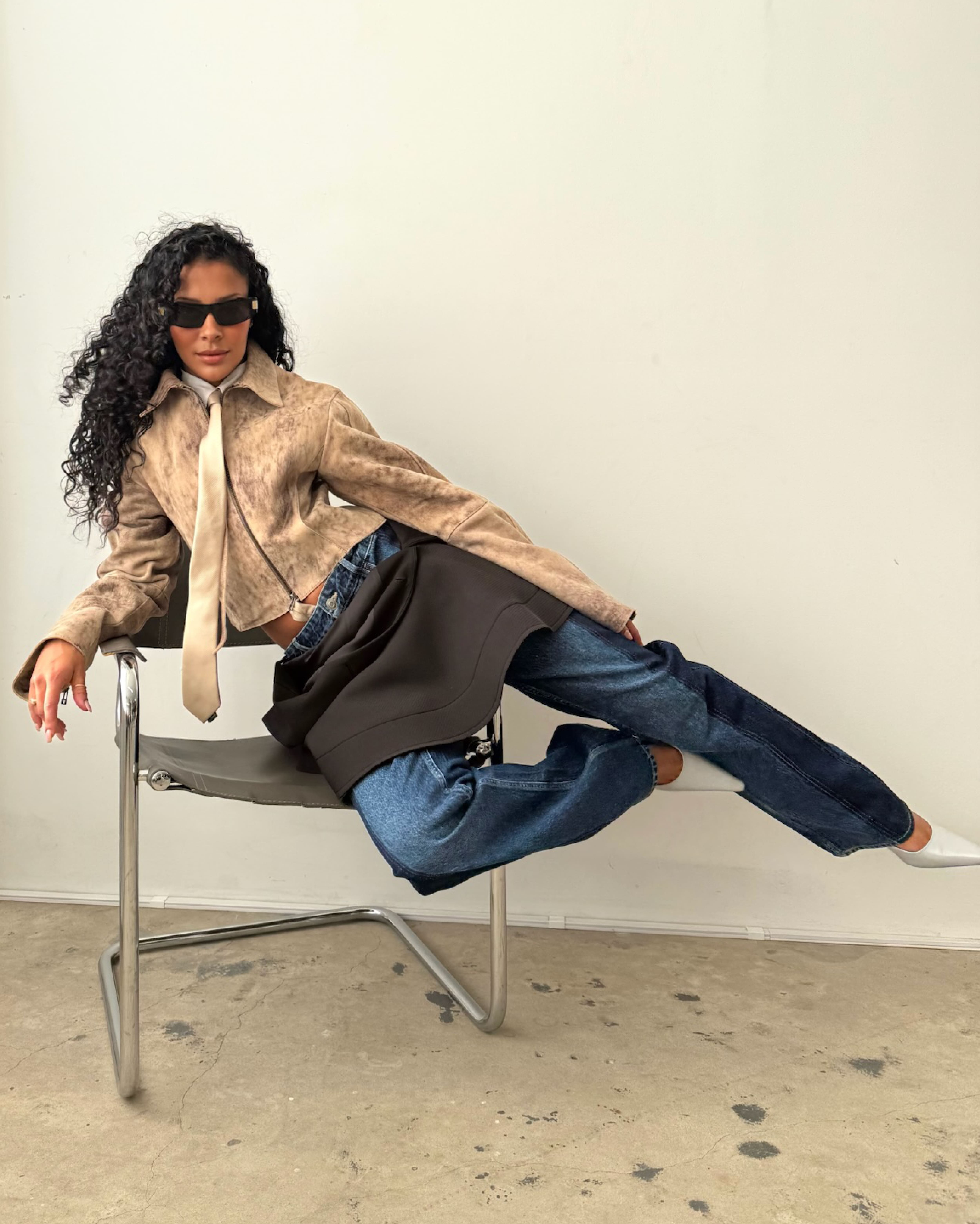 Model wearing a leather jacket and denim
